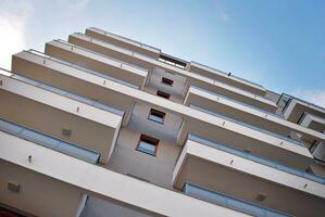 Brand new apartment building on sunny day. Modern residential architecture. Modern multi-family apartment house. photo