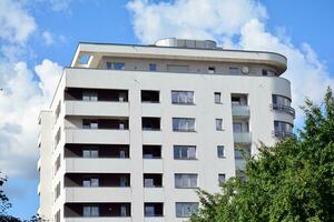 Brand new apartment building on sunny day. Modern residential architecture. Modern multi-family apartment house. photo