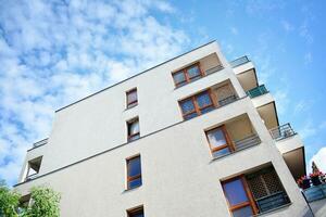 Brand new apartment building on sunny day. Modern residential architecture. Modern multi-family apartment house. photo