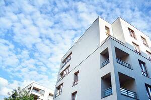 Brand new apartment building on sunny day. Modern residential architecture. Modern multi-family apartment house. photo