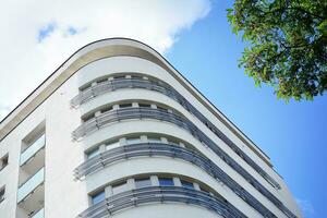 Brand new apartment building on sunny day. Modern residential architecture. Modern multi-family apartment house. photo