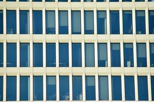 Glass building with transparent facade of the building and blue sky. Structural glass wall reflecting blue sky. Abstract modern architecture fragment. Contemporary architectural background. photo