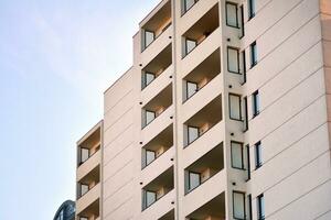 Brand new apartment building on sunny day. Modern residential architecture. Modern multi-family apartment house. photo