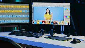 Photo editing software on PC display and graphic tablet on desk in empty multimedia creative studio. Industry standard retouching program on computer screen and touchscreen device, panning shot video