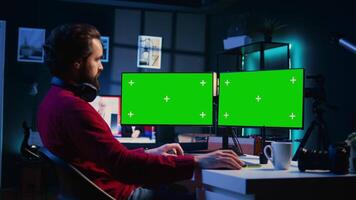 Photographer using photo editing software on mockup multi monitors setup to improve images quality. Photo editor utilizing specialized photographs retouching application on isolated screen display video