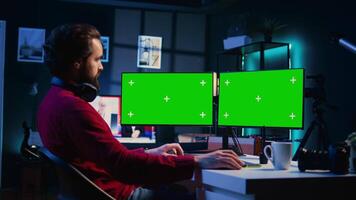 Photographer using photo editing software on mockup multi monitors setup to improve images quality. Photo editor utilizing specialized photographs retouching application on isolated screen display video