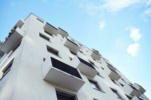 Modern apartment building in sunny day. Exterior, residential house facade. photo