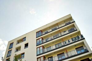 Modern apartment building in sunny day. Exterior, residential house facade. photo