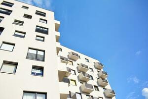 Modern apartment building in sunny day. Exterior, residential house facade. photo