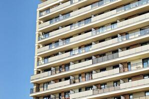 Modern apartment building in sunny day. Exterior, residential house facade. photo