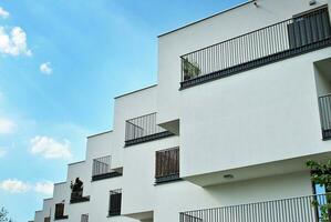 Modern apartment building in sunny day. Exterior, residential house facade. photo