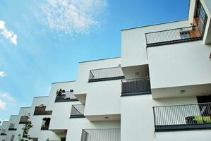 Modern apartment building in sunny day. Exterior, residential house facade. photo