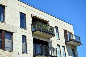 Modern apartment building in sunny day. Exterior, residential house facade. photo