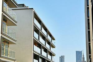 Modern apartment building in sunny day. Exterior, residential house facade. photo