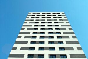 Modern apartment building in sunny day. Exterior, residential house facade. photo