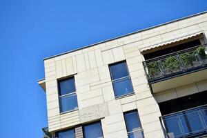 Modern apartment building in sunny day. Exterior, residential house facade. photo