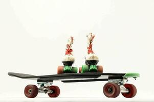 a skateboard with two roller skates on top photo