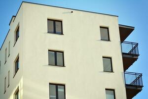 Modern apartment building in sunny day. Exterior, residential house facade. photo