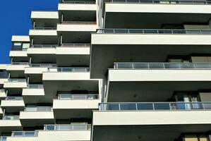 Modern apartment building in sunny day. Exterior, residential house facade. photo