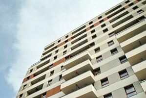 Modern apartment building in sunny day. Exterior, residential house facade. photo