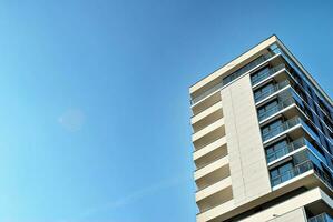 Modern apartment building in sunny day. Exterior, residential house facade. photo