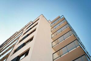 Modern apartment building in sunny day. Exterior, residential house facade. photo