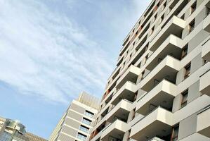 Modern apartment building in sunny day. Exterior, residential house facade. photo