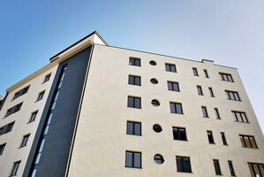 Modern apartment building in sunny day. Exterior, residential house facade. photo