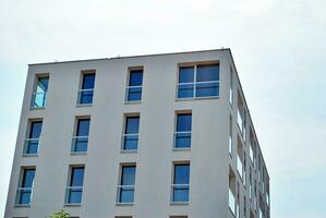 Modern apartment building in sunny day. Exterior, residential house facade. photo