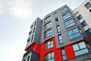 New apartment building with glass balconies. Modern architecture houses by the sea. Large glazing on the facade of the building. photo