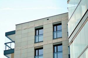 New apartment building with glass balconies. Modern architecture houses by the sea. Large glazing on the facade of the building. photo