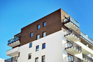 New apartment building with glass balconies. Modern architecture houses by the sea. Large glazing on the facade of the building. photo