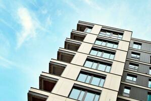 New apartment building with glass balconies. Modern architecture houses by the sea. Large glazing on the facade of the building. photo