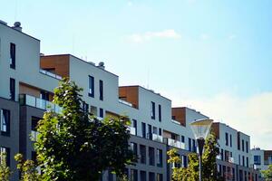 New apartment building with glass balconies. Modern architecture houses by the sea. Large glazing on the facade of the building. photo