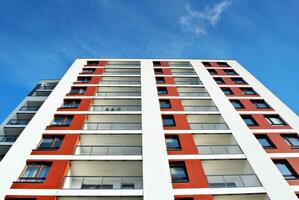 New apartment building with glass balconies. Modern architecture houses by the sea. Large glazing on the facade of the building. photo