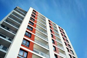 New apartment building with glass balconies. Modern architecture houses by the sea. Large glazing on the facade of the building. photo