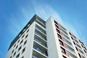 New apartment building with glass balconies. Modern architecture houses by the sea. Large glazing on the facade of the building. photo