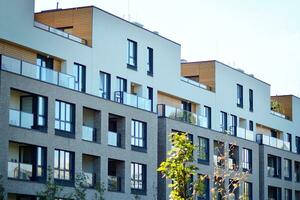 New apartment building with glass balconies. Modern architecture houses by the sea. Large glazing on the facade of the building. photo