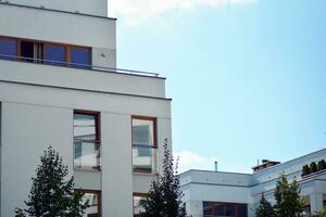 New apartment building with glass balconies. Modern architecture houses by the sea. Large glazing on the facade of the building. photo