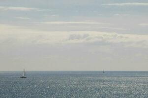 a sailboat is out on the ocean photo