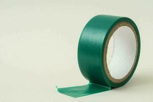 a roll of green tape on a white surface photo