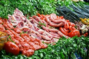 meat and vegetables are displayed on a table photo