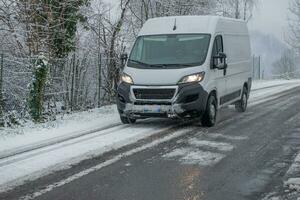 Delivery van on snowy road photo