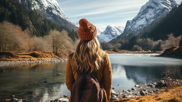 AI generated Female hiker in winter hat enjoying calm lake view. Generative AI photo