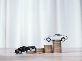 Toy cars with stack of coins. The concept of saving money and manage to success transport business photo