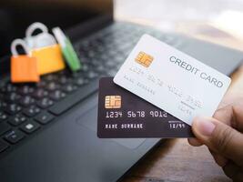 Woman hand holding credit card, Shopping bags on a laptop keyboard. The concepts about Business E-Commerce and online shopping that offers home delivery photo