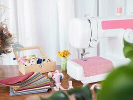 Close up of sewing machine working with red fabric,  stitch new clothing. photo