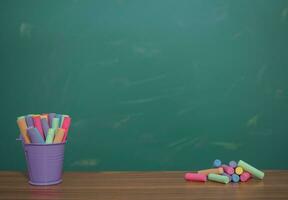 Multicolor chalk on wooden with backboard for education background photo