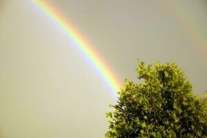 Rainbow against dark threatening sky photo