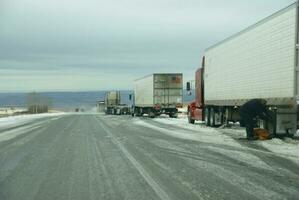 Trucks stop to remove chains photo